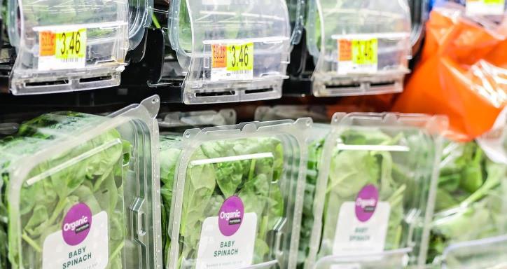 Store shelves with bagged vegetables.