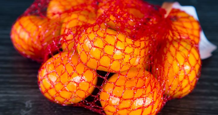 Mandarins in red plastic mesh bag.