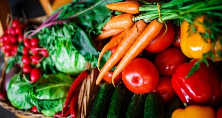 box with carrots, red peppers, cabbage, cucumbers and radishes